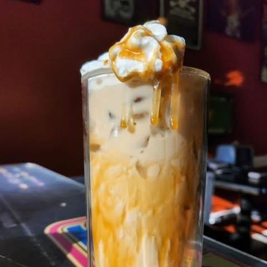 An iced Nook Nog with whipped cream and caramel