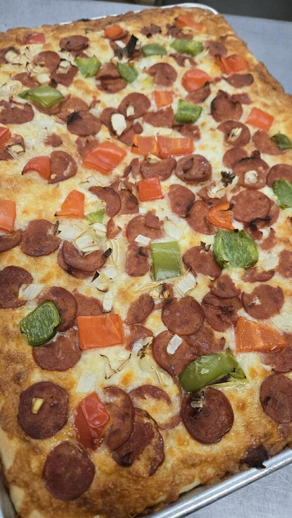 Pepperoni focaccia pizza with peppers and onions