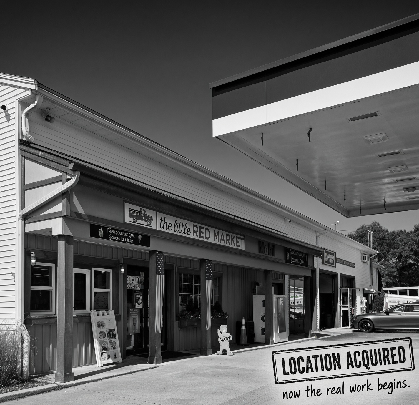 The Plymouth storefront in black and white, stamped location acquired